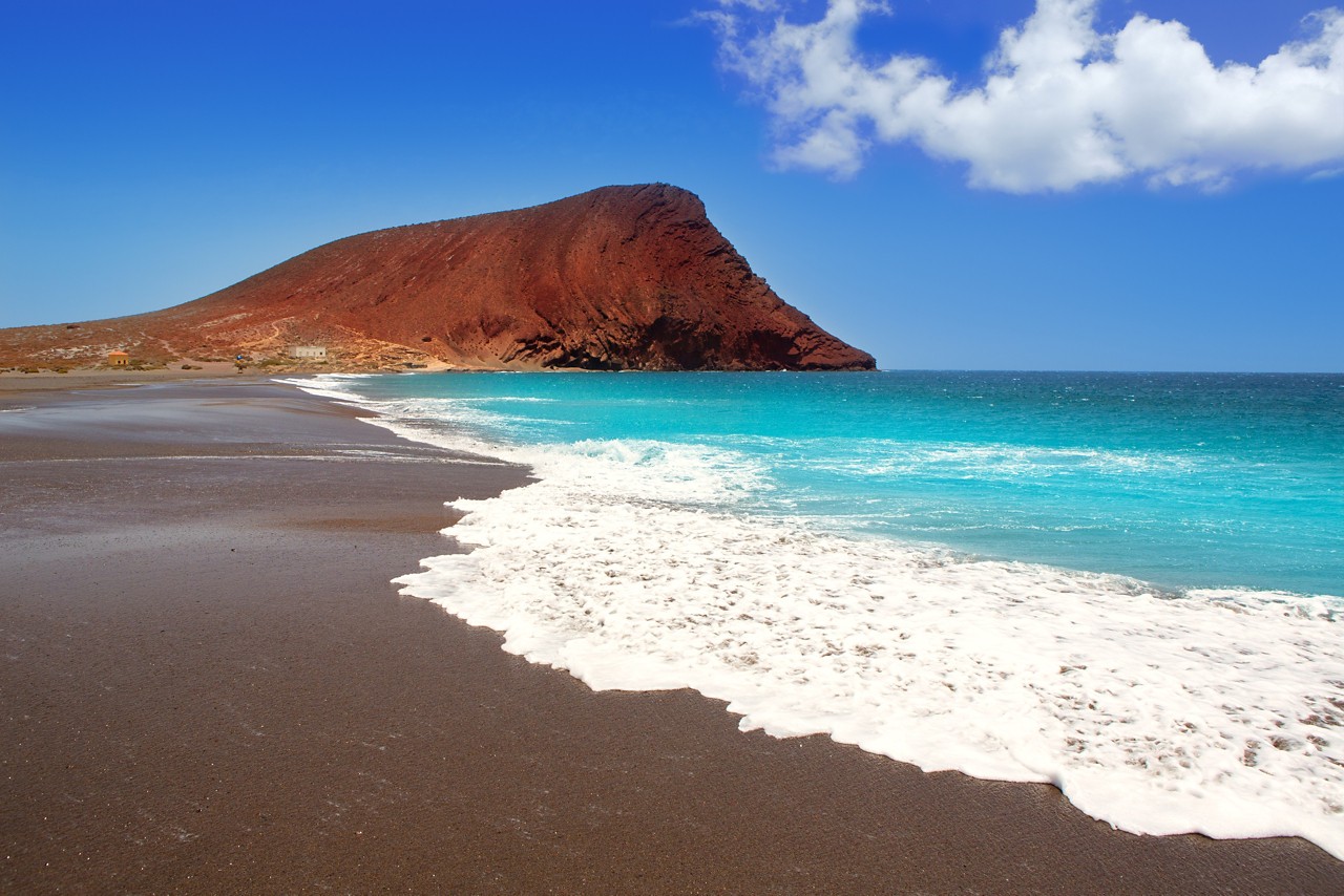 La Tejita Tenerife: Black sand beach with a mountain at sunset