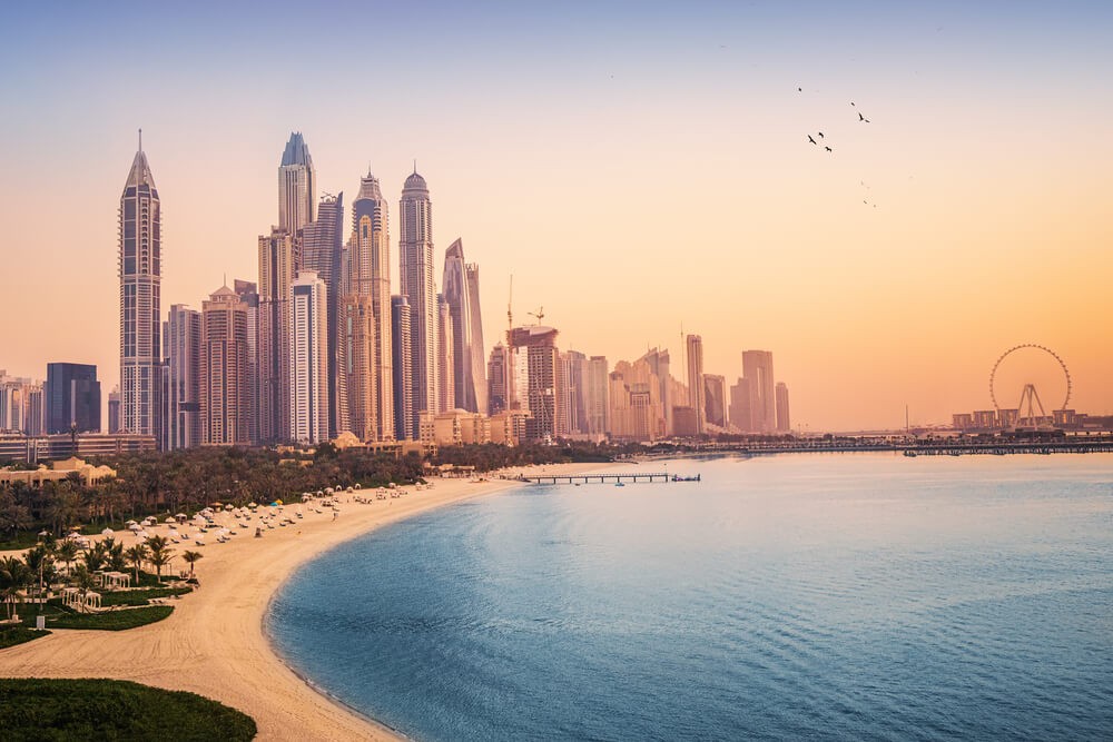 Dubai Beaches: Sun setting over Sunset Beach with the Dubai skyline in the distance 