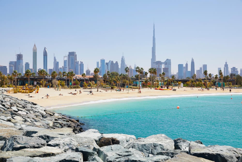 La Mer Beach: A busy, bustling beachfront with Dubai city in the background