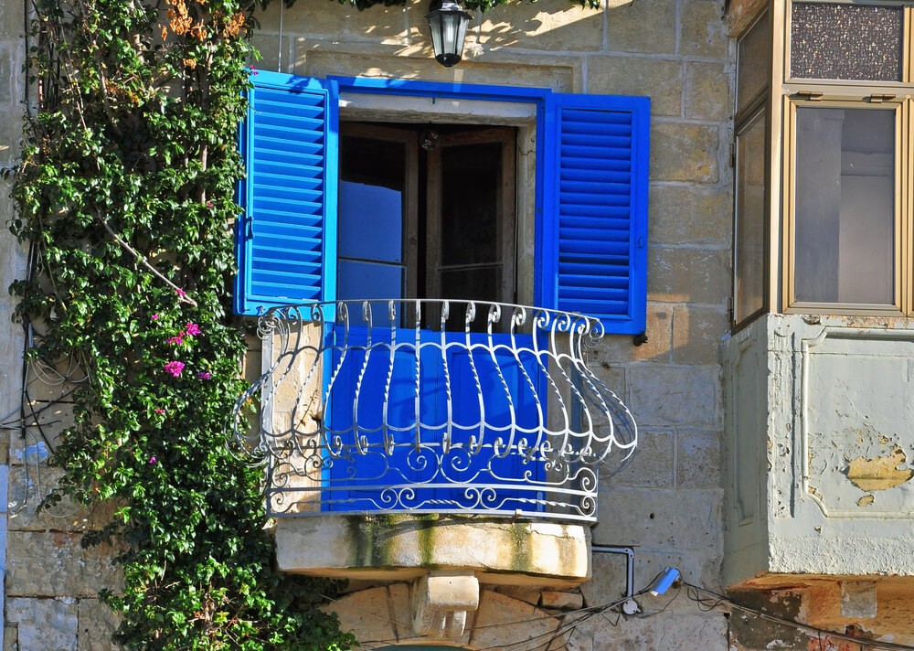 Malta’s good luck ritual: A typical Maltese building with blue shutters open