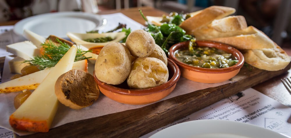 Canarian food: A wooden board filled with cheese, potatoes and bread