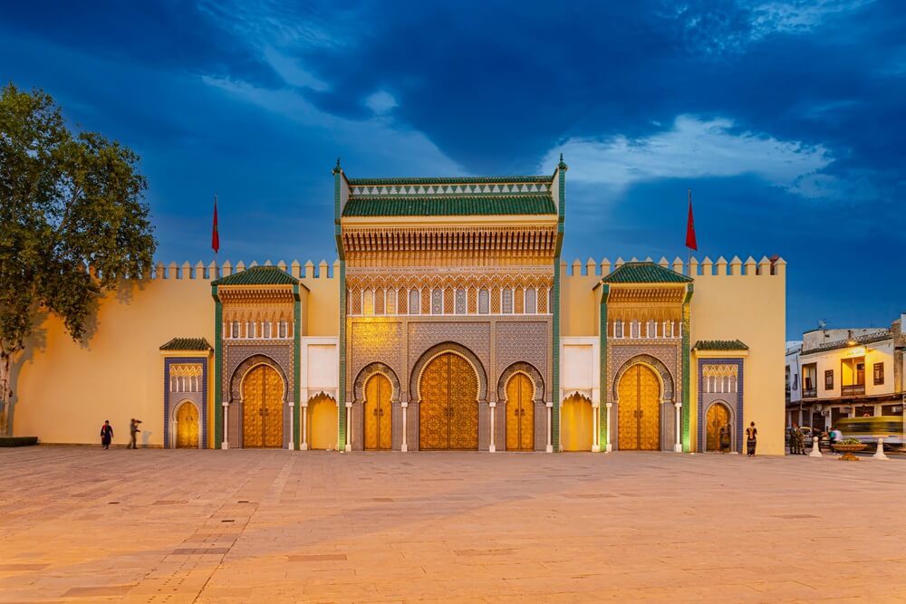 Royal Palace of Casablanca: A cream turreted facade with an elaborate green entrance