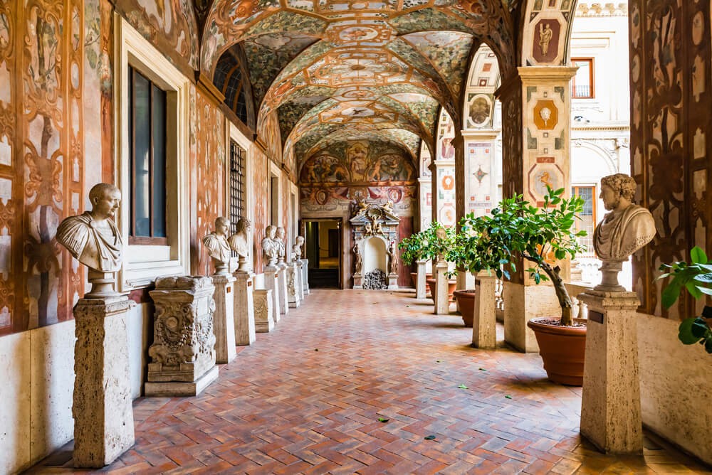 National Roman Museum: Red tiled patio decorated with frescoes and statues